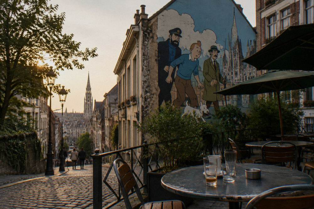 A painted mural of comic book characters on the gable end of a Brussels townhouse