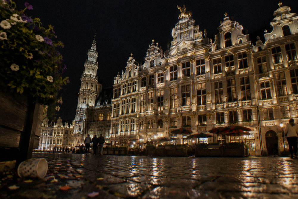An evening view of illuminated guild facades on a Brussels square