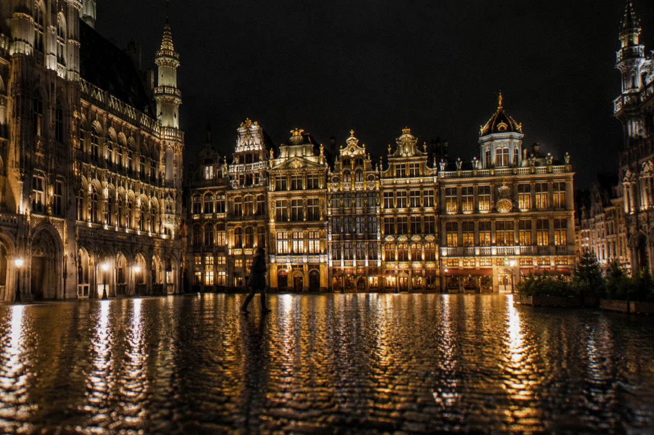Illuminated Grand-Place square in Brussels at night with lit guildhous facades