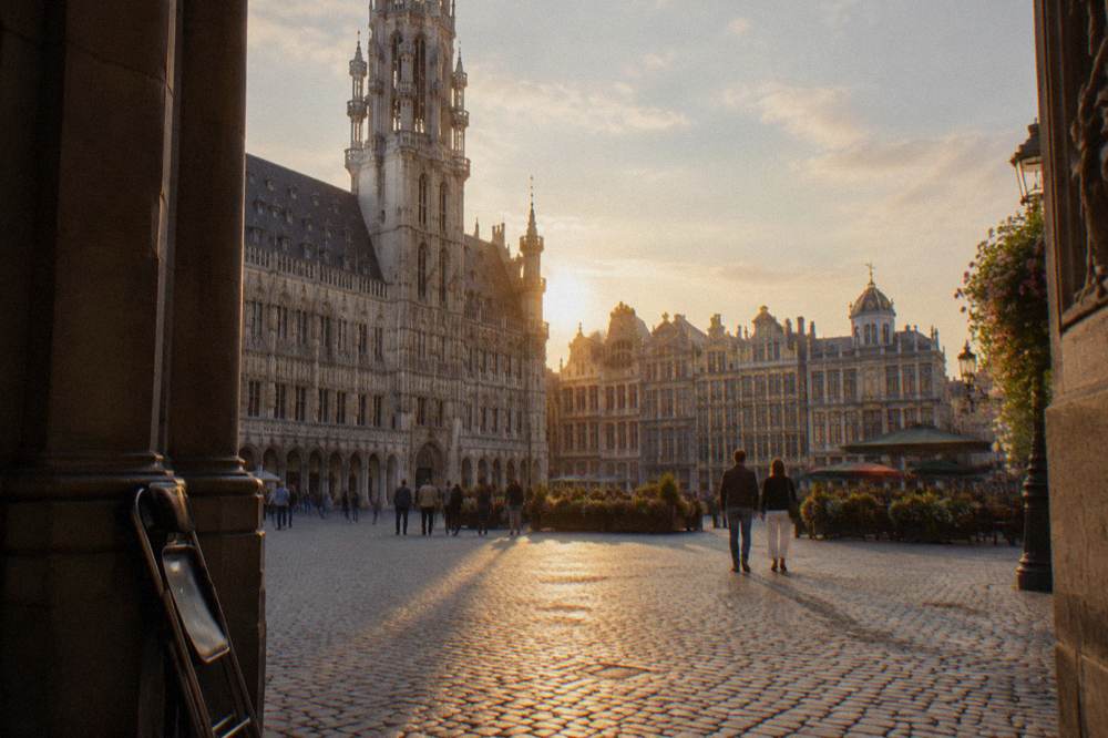 The Grand-Place in Brussels with guildhalls and the City Hall tower under a daytime sky