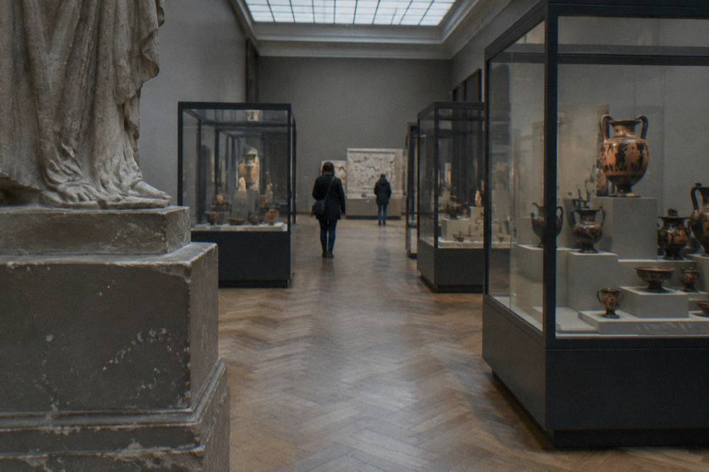 Museum galleries with display cases and sculpture inside the Art and History Museum