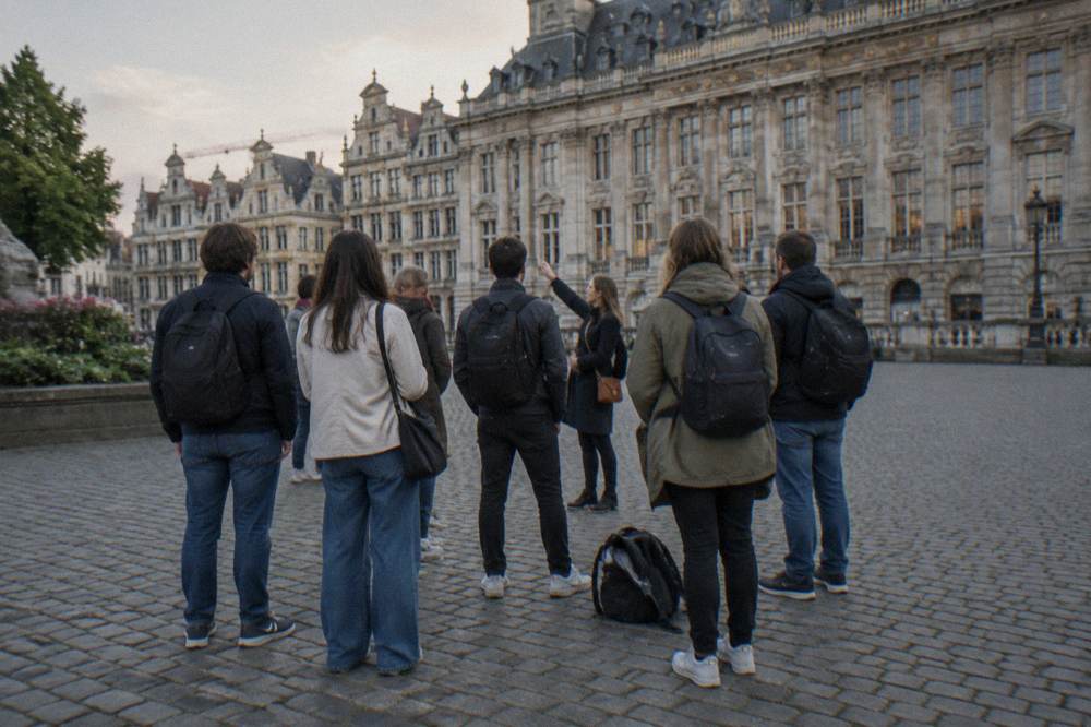 A guided walking group gathered on a cobbled square in Brussels with a guide standing at the front