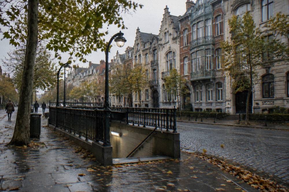 City street with a metro entrance sign and old facades along the pavement