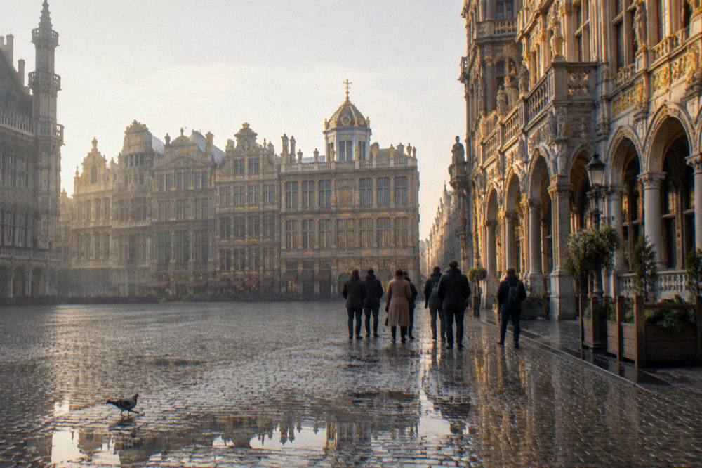 Group of walkers standing on a cobbled square beside historic guild buildings