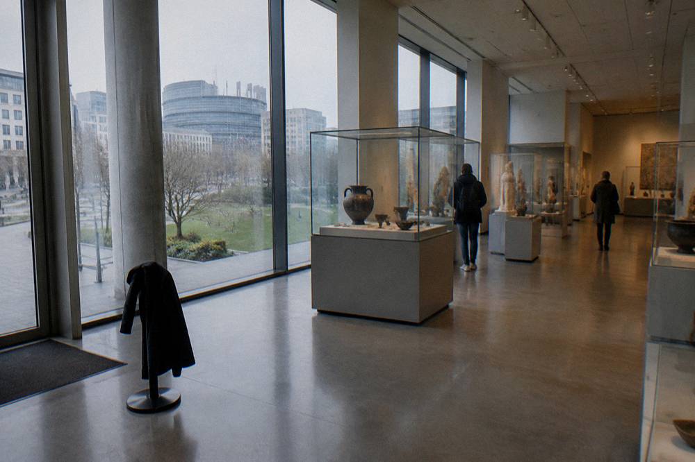 Museum gallery interior with display cases and overhead lighting