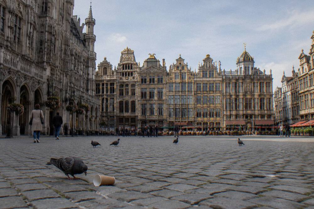 The open cobblestoned square of Grand-Place with ornate gabled buildings on all sides
