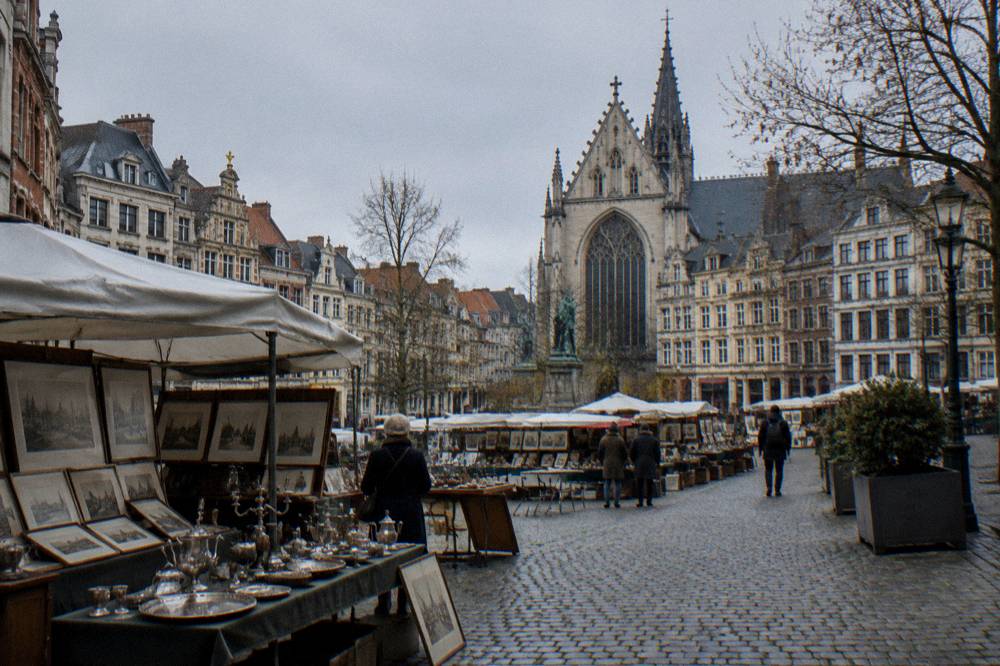 An open city square lined with historic townhouses and cafe fronts in central Brussels