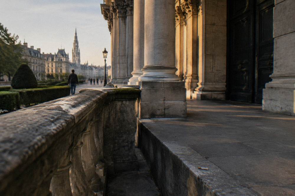 Columned entrance of the Royal Palace of Brussels with closed doors and stone balustrade
