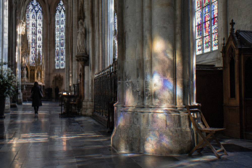 The interior of a Brussels church with stone columns and high windows